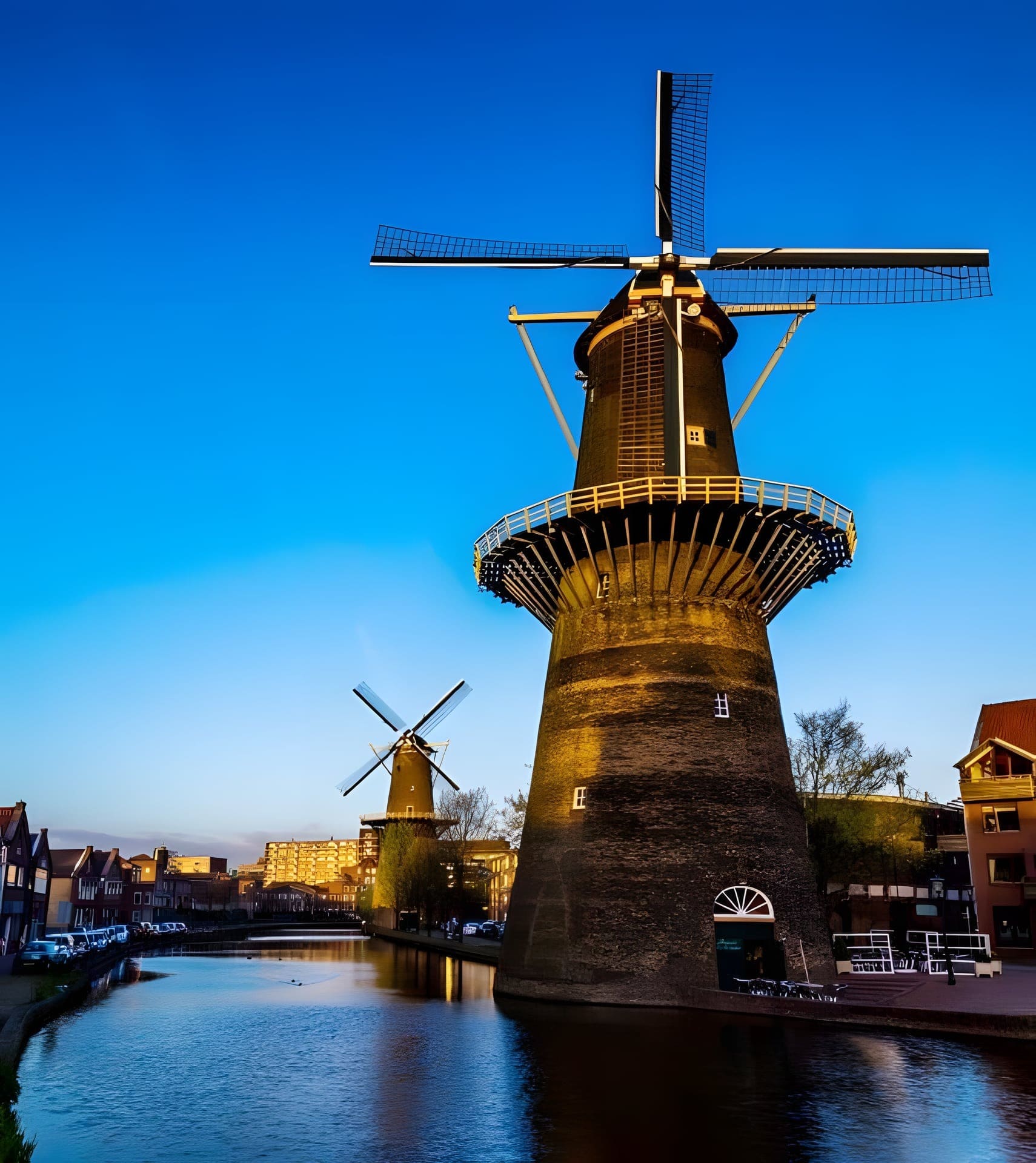 De Noordmolen in de avondschemering, met een tweede molen en de Schiedamse huizen aan het water op de achtergrond